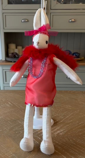 Flapper handmade fabric doll wearing a red satin dress and red feather boa with a chain necklace