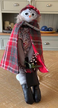 Owlivia handmade owl doll wearing a tartan cape and holding winter berries