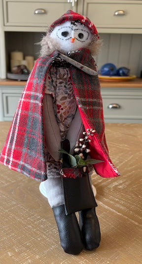 Owlivia handmade owl doll wearing a tartan cape and holding winter berries